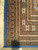 Corner close-up showing border bands, ivory hooked devices and blue overcast selvage beside fringe