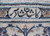 Detail of the top border cartouche with a signature woven in dark Persian script