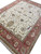 Three-quarter view of the complete rug showing field lattice and the wide red border