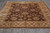 Rug photographed from one end, showing both long borders and the fringed edge