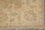 Border corner detail with guard stripes, leaf motifs and white cotton fringe on tile
