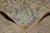 Corner turned back to show the woven reverse, fringe and the border seen from behind
