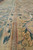 Close low-angle shot along the inner guard stripe where green border meets the tan field