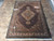 Whole rug photographed from above on stone tile, showing rectangular shape and even pile