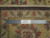 Back of the rug beside a steel ruler, showing even knotting and the border pattern reversed