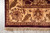 Corner of the rug on grey tile with ivory fringe and border corner resolution
