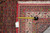 Tape measure and dealer tag laid across the cream border for scale against the red field