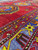 Angled close view across the red field to the blue border with a green eight-pointed star