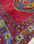 Corner where the open red field meets three guard stripes and the light blue main border