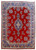 Full overhead view of 9x12 Persian Kerman rug with red field, blue border and ivory medallion