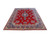 8'11" x 12'5" Kerman rug photographed at an angle showing red floral field and royal blue borders