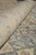 Rolled edge close-up showing dense wool pile, peach guard border and soft grey floral tracery