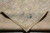 Folded back corner showing the cotton foundation and even knot line of the weave