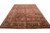 Angled full-length shot showing camel palm tree border, rust floral field and ivory fringe