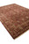 9' x 12'1" Indian Oriental rug photographed from the corner, showing tan border and cotton fringe