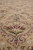 Close-up of floral palmette cluster in burgundy, rose and olive on soft khaki wool pile