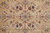 Small lobed rosette medallion with symmetrical rose bouquets at the center of the khaki field