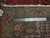 Back of the wool rug with ruler confirming authentic handmade knotting and genuine oriental rug tag