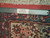 Ruler across the border measuring knots per square inch on this authentic handmade Persian Sarouk rug