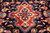 Detail of the navy medallion field with coral centerpiece, ivory and gold flowerheads throughout