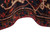 Folded pile showing dense wool thickness, dark navy ground and salmon red border flowers