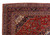 Corner detail of navy main border, ivory spandrel and hand-knotted cotton fringe on Kashan rug
