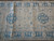 Center field detail with two 8 petal rosettes between solid blue main border bands