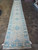 3x20 Khotan runner shown in full with ivory fringe ends and all-over rosette layout