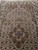 Camel brown lobed medallion centered in Herati lattice field with burgundy rosettes and silk sheen