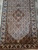 Mahi design runner section with rust medallion, dense fish lattice and ivory palmette border