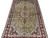 Angled close view of carved silk pile, celadon medallion and dense gold floral field
