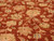 Close up of cream palmettes, sage leaves and flowering vines on rust wool pile