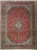 Red Persian Kashan rug with navy floral border, ivory medallion and dense all-over flowering vine field
