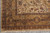 Corner border detail with brown, gold and olive palmettes above hand-tied ivory fringe