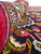 Rolled edge revealing dense knotting, even wool pile height and the multicolor border palette