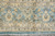 Main border detail with apricot palmettes and olive vinework on a soft faded blue ground