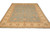 9'1" x 12' hand-knotted Pakistani wool rug at an angle showing aqua field and gold border