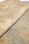 Close-up of plush wool pile thickness where the ivory border meets the aqua green field