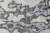 Close-up of wool and silk pile showing cloudlike charcoal shapes with blue-gray shading and silk sheen