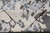 Folded corner revealing ivory reverse and tight hand-knotted weave of this contemporary Indian wool silk rug