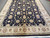 Angled view of cream border scrollwork framing the deep black vine and palmette field