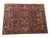 Angled view of rust and olive green hand-knotted wool Ziglar rug, 9x12 all over floral