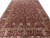 9' x 12' hand-knotted Oriental rug showing camel border with deer, palm trees and rosettes
