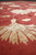 Ivory and champagne silk blossoms with trailing vine, modern Oriental rug detail at floor level