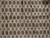 Close-up of camel beige field showing repeating octagonal guls and cross motifs in charcoal and gold