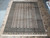 9' x 12' Bokara Oriental rug laid flat on travertine tile, warm ivory beige field