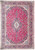 Red Persian Kashan rug with ivory lobed medallion and dark indigo floral border, full overhead view