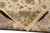 Back of hand-knotted rug folded over, revealing fine cotton foundation and even knot rows