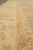 Border guard stripes in gold and ivory photographed at floor level on wool rug