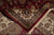 Folded corner revealing wool pile depth, ivory guard borders and hand-tied cotton fringe ends